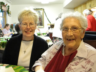 Prioress Sister Clarissa Goeckner expresses birthday wishes to Sr. Mercedes at the celebration of her 99th birthday.