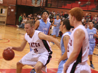 Devin Schmidt handles the ball in the lane as David Johnson sets a pick.