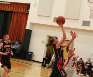 Megan Sigler goes for a lay-up after a Kendrick turnover. MeShel Rad trails the play.