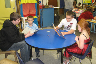 Prairie Faith Formation students read with Kindergartners.