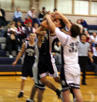 Michael Waters had a hard time getting this shot off in Summits game at Grangeville. In the background is Austin Chmelik.