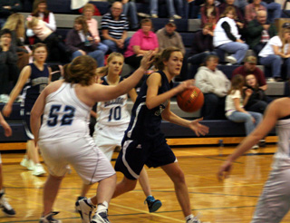 Savanah Prigge catches a pass and draws defenders. In the background is Rachel Wemhoff.