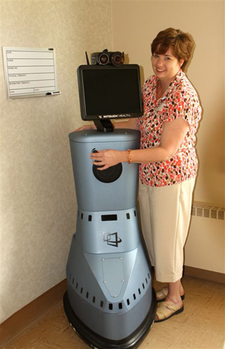 Stephanie Wagner, SMH Clinics Coordinator, sets up the RP-7 robot for the telepsychiatrist/patient visits at the SMH Cottonwood Clinic.  SMHC and Clearwater Valley Hospital and Clinics recently received two grants to help fund the program.