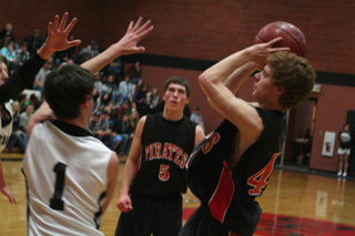 Brock Heath shoots against Deary. Watching is Seth Guyer.