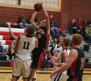 Devin Schmidt gets inside the lane for a shot against Deary. At right is David Johnson.