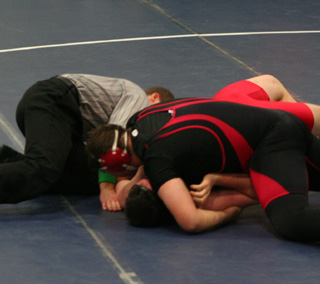 Mitch Jungert powers down as he is about to pin David Northrup of Wallace. Jungert was 2nd in the 285 lb. class.