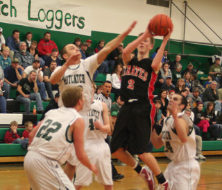 Beau Schlader puts up a shot in the lane at Potlatch. At left is David Johnson.