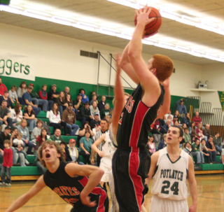 David Johnson shoots over a Potlatch defender. Justin Schmidt gets ready for a rebound.