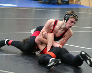 Kade Perrin hooks an arm as he tries to roll over his opponent.