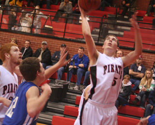 Seth Guyer lays the ball up against Genesee. At left is David Johnson.