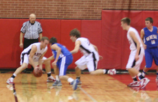 Devin Schmidt grabs the ball in the Genesee game after Justin Schmidt, middle, had knocked it loose. At right is Beau Schlader.