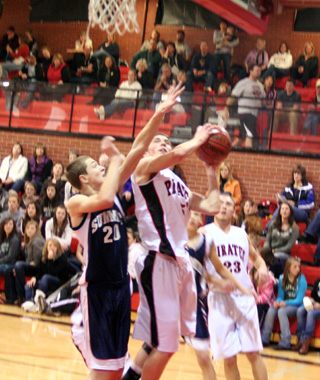 Prairies Seth Guyer tries to get a shot up against Summits Austin Chmelik. In the background is Prairies Devin Schmidt.