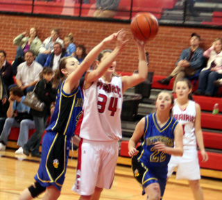 Shelby VonBargen gets fouled on this shot against Genesee. At right is Meaghan Bruner.