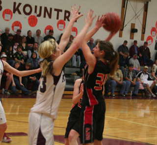 Shelby VonBargen looks to get a shot up over Kamiah's Shelby Cloninger.