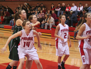 Samantha Keating, 14, and Kayla Johnson block out for a rebound as Callie Mader, 2, watches the ball.