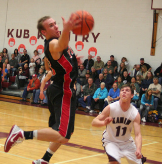 Devin Schmidt reaches to grab the ball in the game against Kamiah. The Kamiah player is Jack Nygaard, grandson of Cottonwoods Rita Riener.