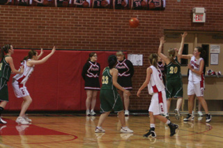 Senior connection-Meaghan Bruner passes into the low post to Kayla Johnson. Also shown is Callie Mader.