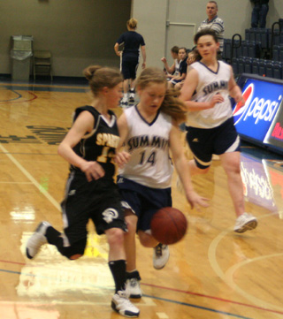 Nicole Wemhoff handles the ball against Timberline at District as Nicole Frei trails the play.