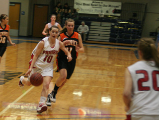 Megan Sigler drives past a Kendrick defender. In the background is MaKayla Schaeffer and at right is Kendall Schumacher.