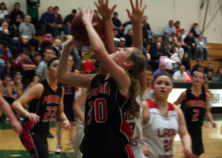 Tanna Schlader tries to get a shot up against Lakeside. At left is MeShel Rad and at right is Callie Mader.