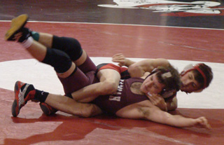 Tayler Heitman has Kamiah's Anthony Lott all wrapped up. Photo by Kayla Raymond.