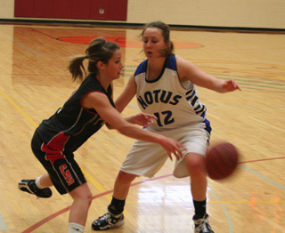 Callie Mader passes into the lane against a Notus defender.