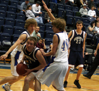 Derek Nuxoll maneuvers for a shot. At right is David Waters.