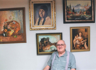Ladd Arnoti with some of his paintings. He is the Prairie Community Library Artist/Author of the month. Photo provided by Dorothy Arnoti.