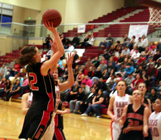 MaKayla Schaeffer puts up a shot against C.V. as Kendall Schumacher watches.
