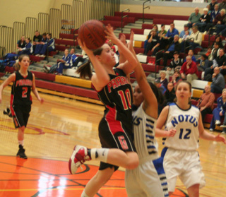 Megan Sigler pus up a shot in the Notus game. At left is Callie Mader.