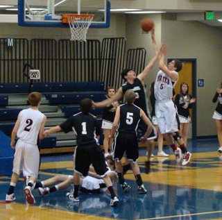 Seth Guyer extends for a shot against Deary as Beau Schlader watches and Justin Schmidt tries to pick himself up off the floor. Photo by Kayla Raymond.