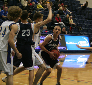 Shane Stubbers looks to get up a shot in the district game against Nezperce. At left is David Waters.
