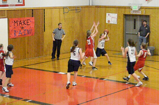 Jolene Chmelik looks to pass to Megan Seubert (#21), Kaitlin Stubbers (#5) and Rachel Waters (#23) during Hallissey Tournament action. Hallissey photos provided by Summit Academy.