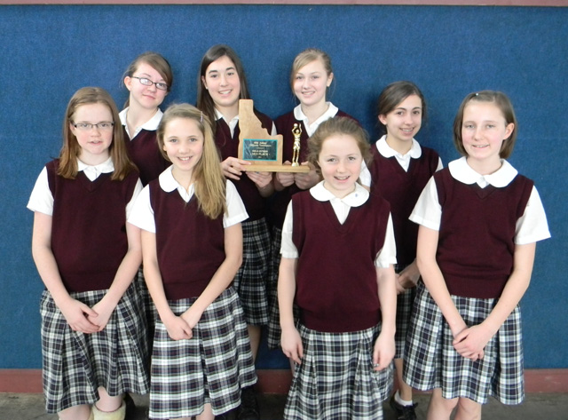 The Summit Academy team with a lot of young fans after winning the District title at Nezperce Saturday. Savanah Prigge is kneeling third from right in front. Other players from left are Megan Rehder, Brooke Schumacher, Rachael Frei, Kayla Duclos, Cassidee Stubbers, Rachel Wemhoff, Sarah Chmelik, Jamie Chmelik,  Abi Chmelik, Nicole Wemhoff and Nicole Frei. In back are coaches Alexia Prigge and Pete Prigge. Photo supplied by Summit Academy.