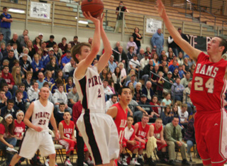 Beau Schlader shoots from the baseline against C.V. At left is Devin Schmidt.