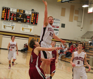 David Johnson puts up a shot for 2 of his game high 19 points against Shoshone in the 3rd place game. At left is Justin Schmidt and at right is Beau Schlader.