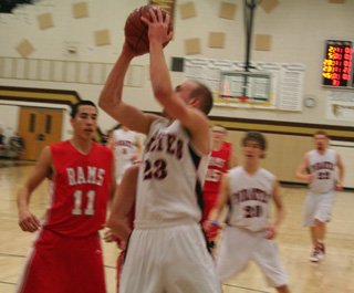 Devin Schmidt scores inside in the C.V. game. At right are Justin Schmidt and David Johnson.