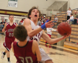 A Shoshone defender tries to draw a charging foul on Justin Schmidt’s shot attempt.