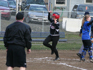 Kendall Schumacher celebrates as she crosses the plate after hitting a grand slam homer at Orofino.