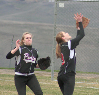 Tanna Schlader goes after a pop fly into short right field as Kendall Schumacher comes on to backup the play in the first Kellogg game.