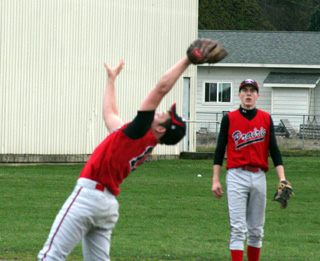 Garrett Schmidt reaches back to catch a pop fly that carried a little farther than he thought. Watching is Seth Guyer.