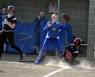 Leah Holthaus slides in with a run against Colton after an errant throw allowed her to score. At left is Kendall Schumacher.