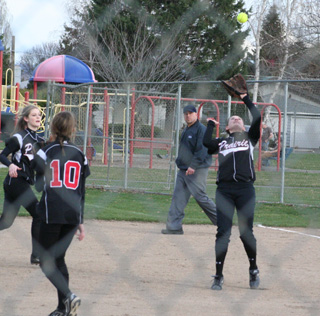 Meaghan Bruner catches a popup in the first Potlatch game. At left are Leah Holthaus and Tanna Schlader.
