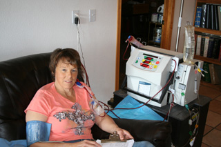 Jill Seubert, hooked up to her NX Stage home hemo machine. A benefit yard sale is set for May to help defray costs of a kidney transplant. Photo provided by Lacey Uhlenkott.