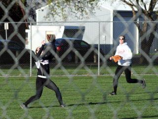 Monica Lustig battles the win to catch a fly ball in the outfield of Prairies first game with Moscow. She made a couple of great running catches in the game as well. At right is Savanah Prigge.