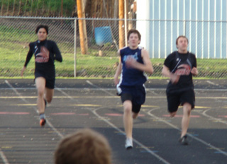 Neto Pereira and Dakota Wilson flank a Grangeville runner in one of the heats of the 200 meter dash at the track meet in Kamiah last Thursday. Photo by Kayla Raymond.
