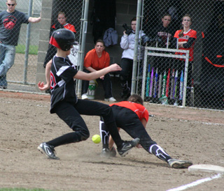 Leah Holthaus pulls into third base ahead of the throw in the second Troy game.