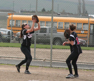 Meaghan Bruner gets under a popup in the second Troy game as pitcher Leah Holthaus is ready for backup.
