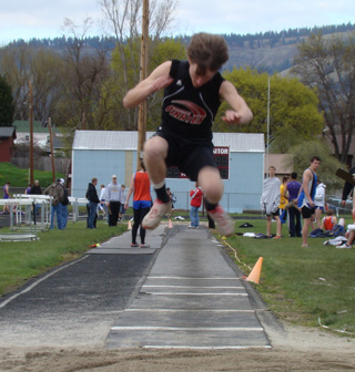 Justin Schmidt flies towards the pit in the triple jump where he broke 40 feet and placed 2nd. Photo by Kayla Raymond.