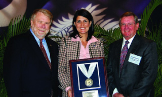 Peter Arnoti, right, is shown with Bobby Hitt, S.C. Dept. of Commerce Secretary and Nikki Haley, Governor of South Carolina at his award presentation.